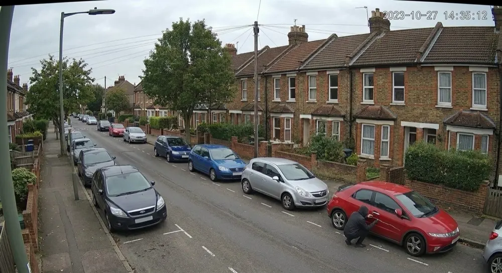 Car vandalism: Generative AI raises alert. Gen AI confirms vandalism — a hooded person keying a parked car.