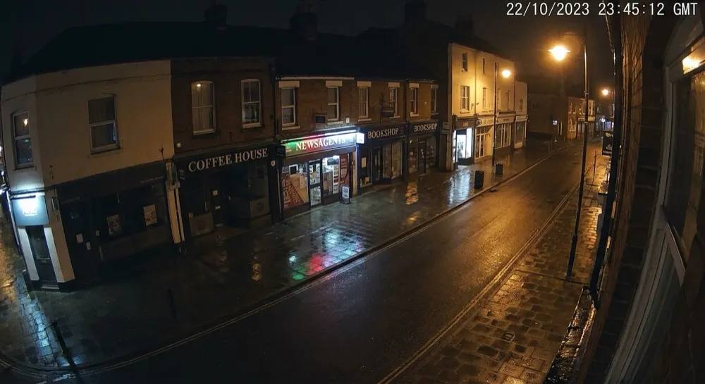Fighting: No motion. No alert — quiet lit street at night.